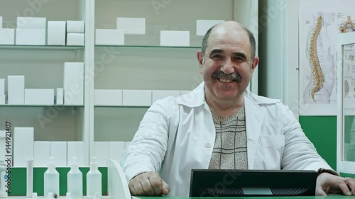 Happy male pharmacist showing allright sign and stumb up smiling