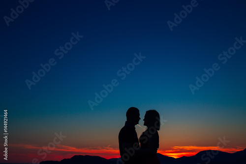 Silhouettes at sunset on the beach in Montenegro