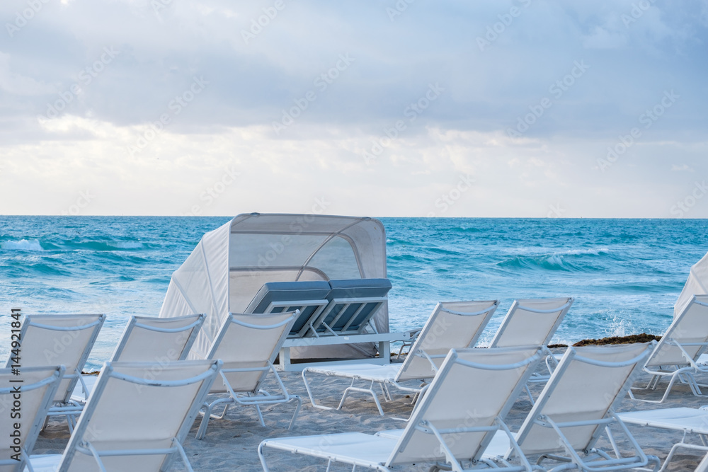 Fototapeta premium White chairs and umbrella on the beach