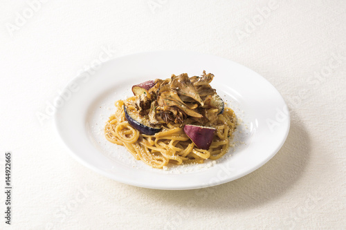 Spaghetti pasta noodle with sweet potatoes and salt on white platter