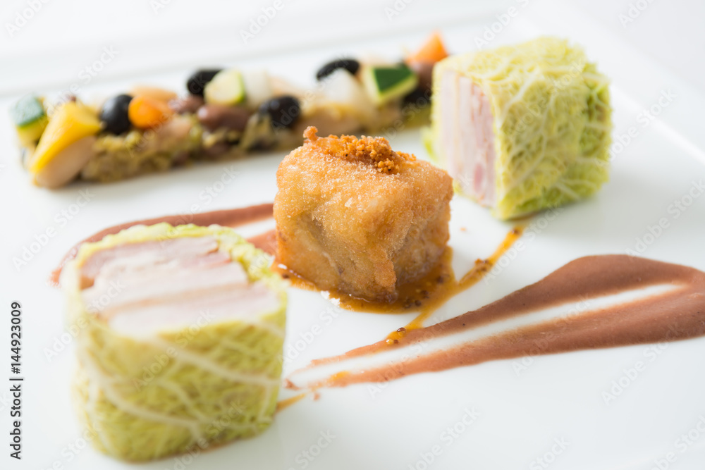 Rolls of pork and white cabbage on white background Rolls of pork and white cabbage on white background