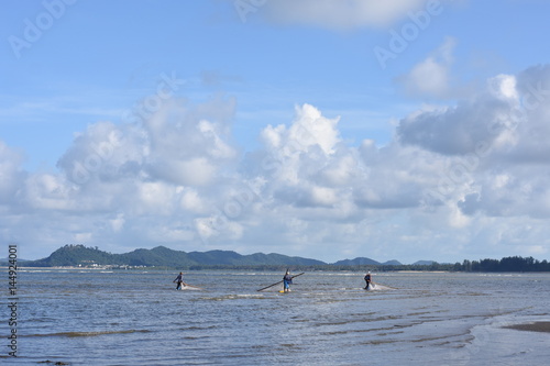 Three men are fishing at the Gulf of Thailand.