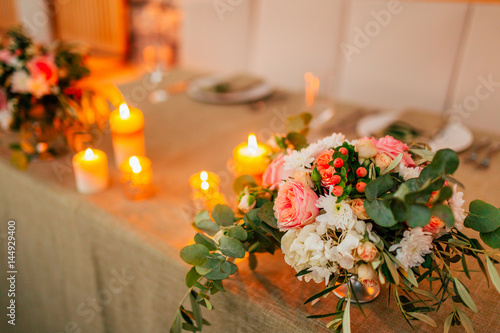 Flower compositions on the wedding table in rustic style. Wedding decorations with their own hands. Wedding in Montenegro.