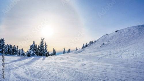 Sun trying to break through the clouds in the high alpine of the ski resort of Sun Peaks in the Shuswap Highlands of central British Columbia, Canada
