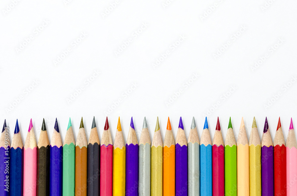 colored pencils on white paper background. colored pencils on white paper background.