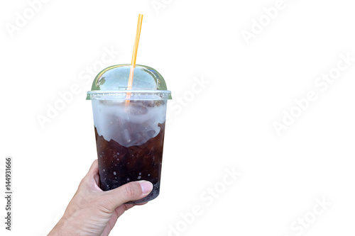 Tableau sur toile Human hand holding soda beverage in the plastic cup with yellow strew
