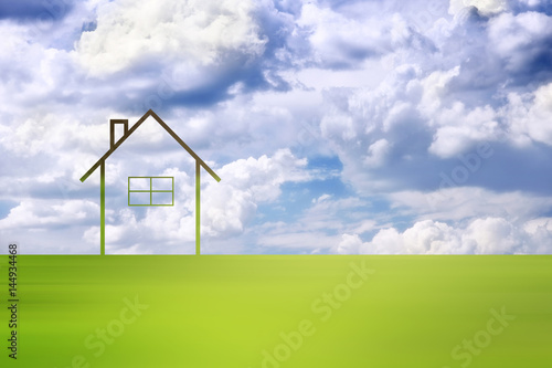 Conceptual eco home healthy living copy space background with motion blurred green meadow and cloudy sky.