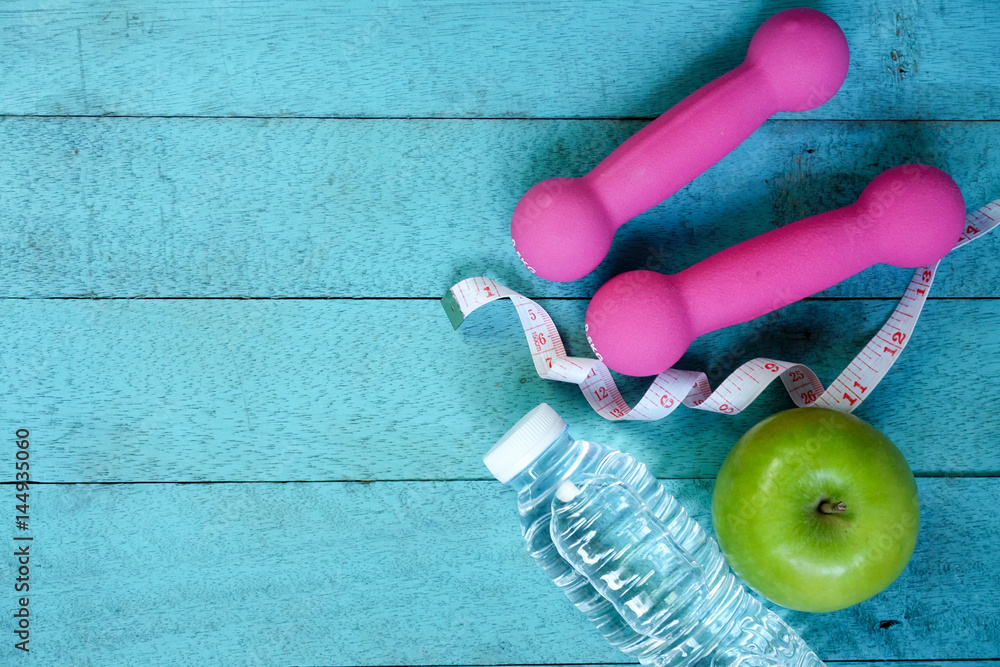 Top view of fitness equipment and nutrition food on blue wooden background. Fitness concept. Top view of fitness equipment and nutrition food on blue wooden background. Fitness concept.