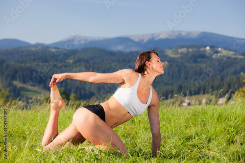 Beautiful young girl doing asana yoga