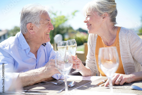 Senior couple enjoying meal in outdoor restaurant