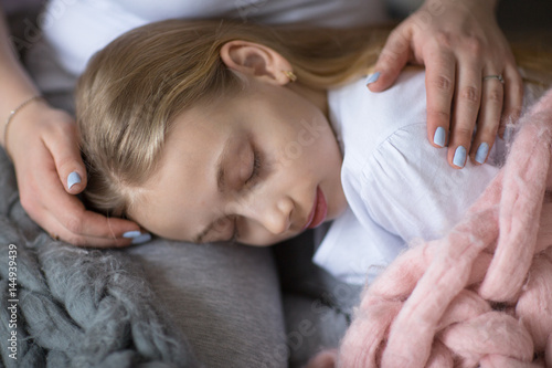 beautiful mom hugs and gently strokes daughter