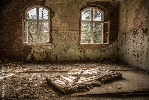 Broken bed, mattress in abandoned hospital and sanatorium Beelitz Heilstätten near Berlin, Beelitz, Germany photo