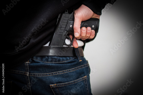 The man hid the gun behind their backs, robbery, crime, kidnapping