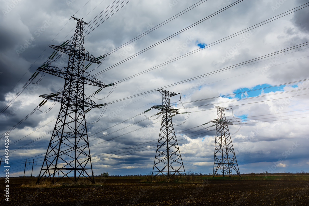 Electricity pylons and lines at dusk at sunset. Electricity pylons and lines at dusk at sunset.
