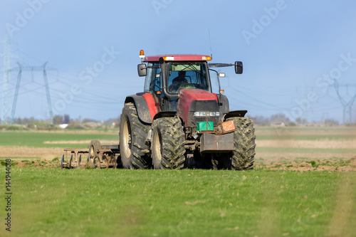 Tractor harrowing the land