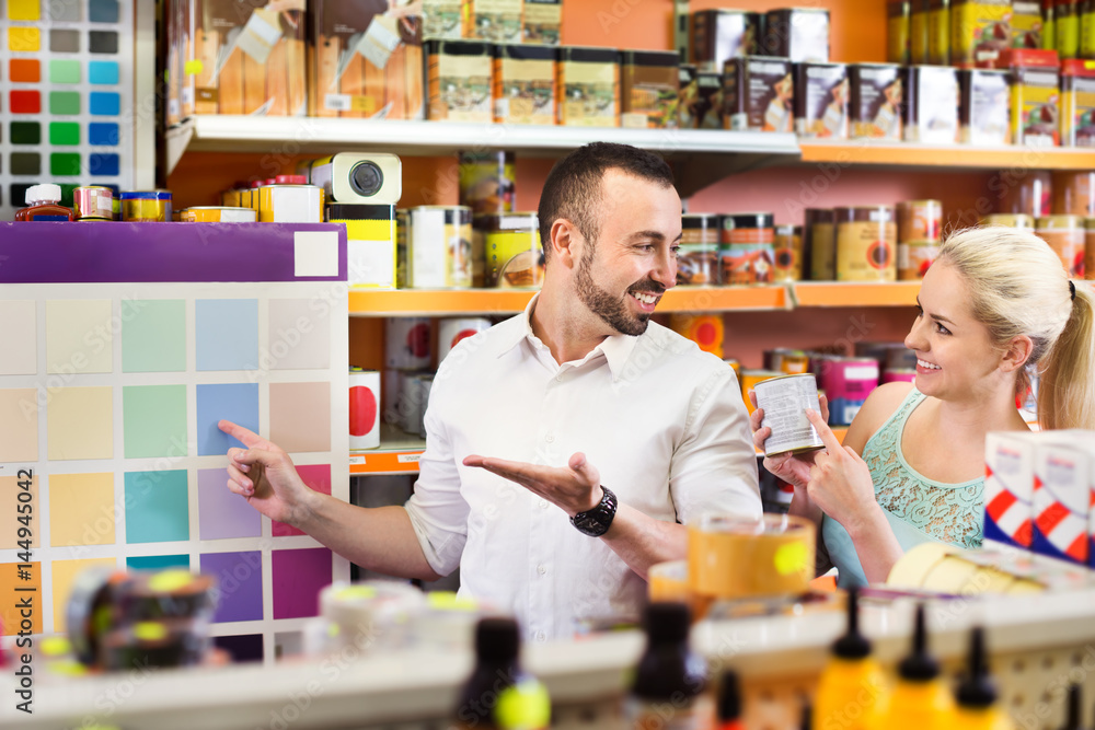 Couple choosing color in household store