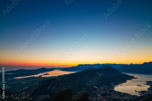 Sunset in Montenegro over the mountains and the sea. Orange sunsets. © Nadtochiy