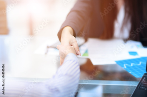 Two confident business man shaking hands during a meeting in office  success  dealing  greeting and partner concept.