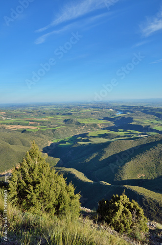 Spring view of the Spanish plain with a river in the canyon, Hoya de Huesca