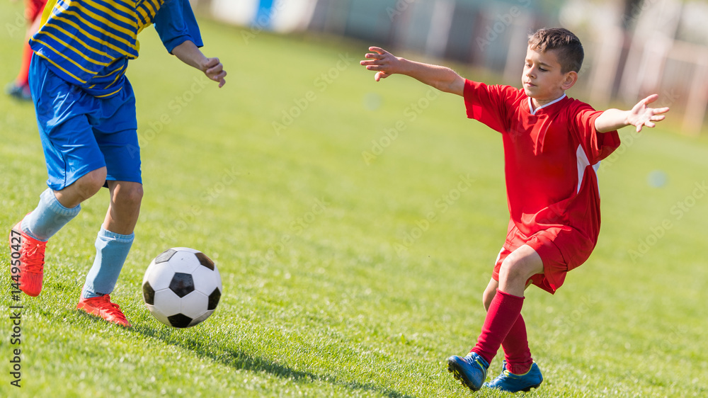 Kids soccer football - children players match on soccer field