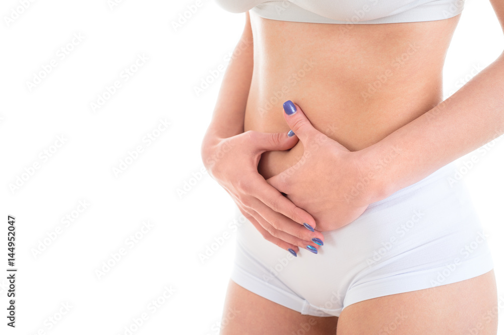 Midsection of female body suffering from stomach ache over white background