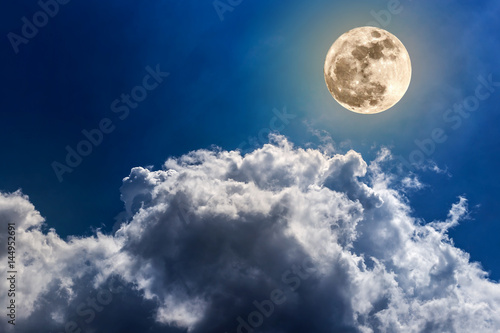 Beautiful Night sky and a full moon in the clouds