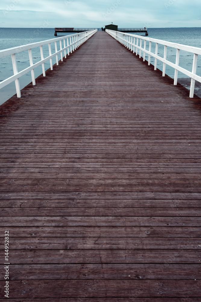 Empty wooden pier walkway on sea shore Empty wooden pier walkway on sea shore