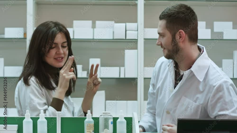 Funny young pharmacist dressed in white uniform dancing at pharmacy Funny young pharmacist dressed in white uniform dancing at pharmacy