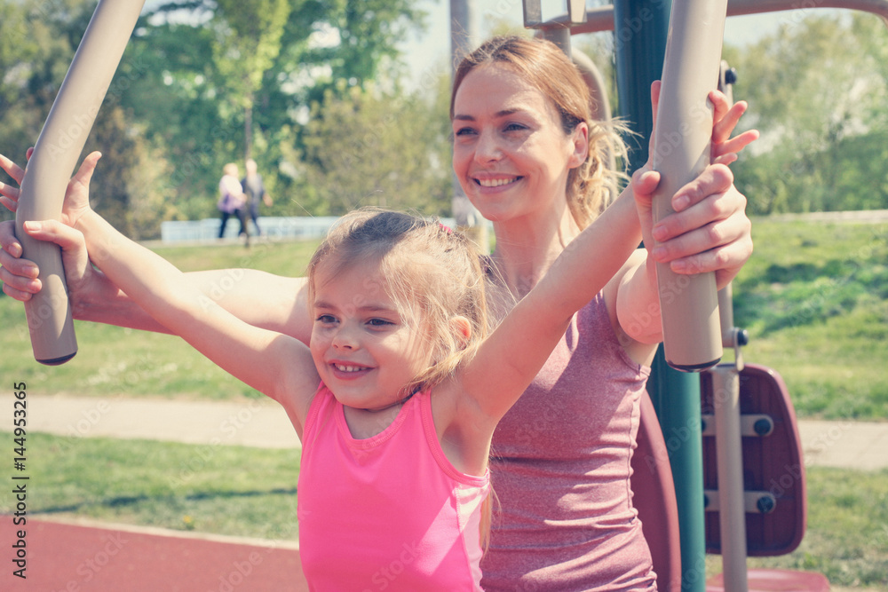 Mother and daughter outdoor exercise. Mother and daughter outdoor exercise.