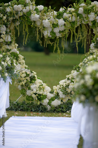 Heart frame made of beautiful flowers. Arch made for wedding ceremony