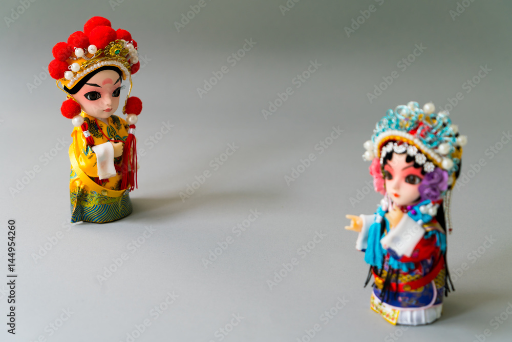 Fototapeta premium Traditional married Chinese dolls isolate on gray background - focusing on groom