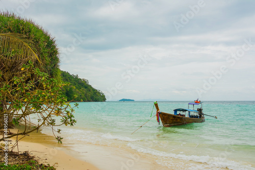 Andaman's island with long tale taxi boats on a beach © yurich84