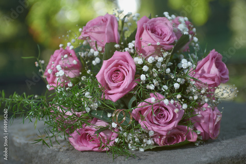pink rose wedding bouquet with two gold ring