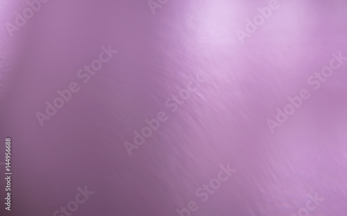 Pink glossy shiny gradient background with a change in color saturation