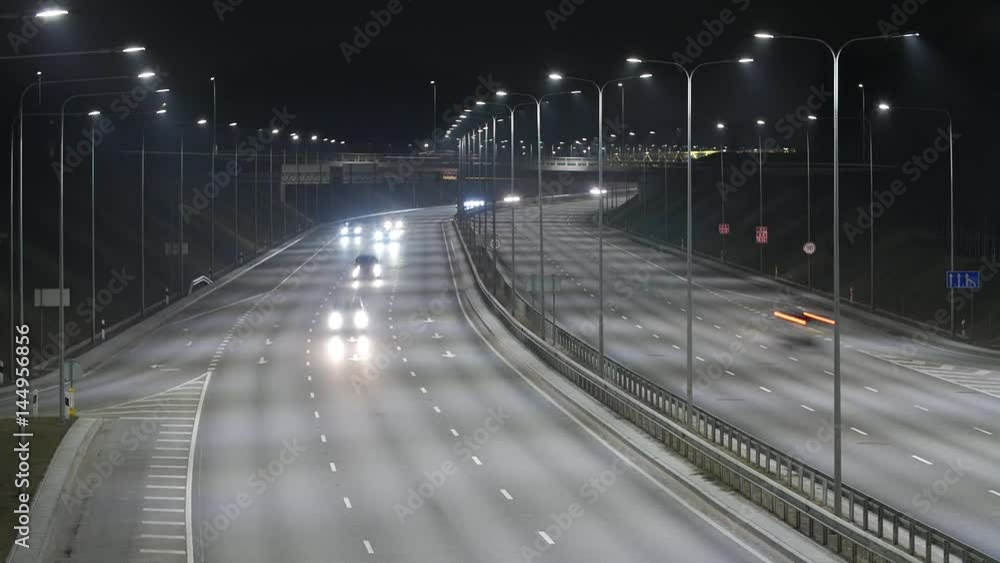 Long Exposure Time Lapse of Western Bypass Night Traffic in Vilnius, Lithuania. High-angle view from a bridge. Long Exposure Time Lapse of Western Bypass Night Traffic in Vilnius, Lithuania. High-angle view from a bridge.