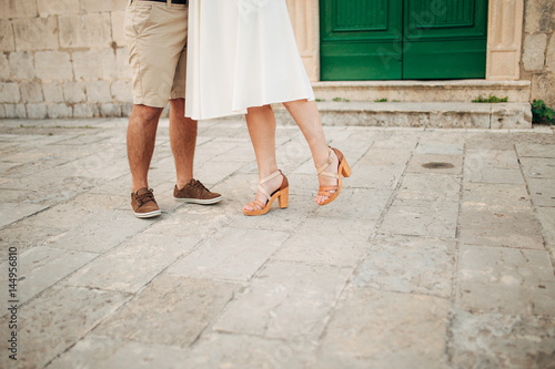Female and male feet on the pavement. Wedding in Montenegro