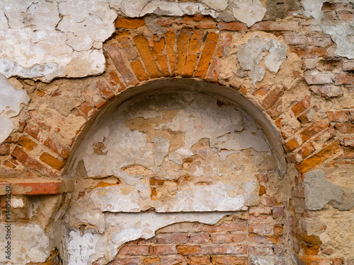 Ruins of a wall destroyed by moisture and precipitation photo