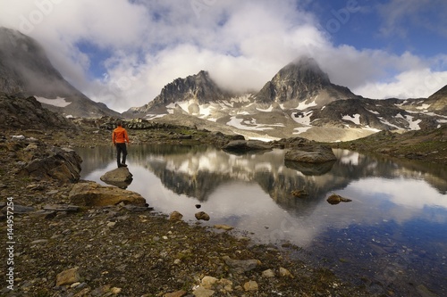 A hiker pauses to watch the Mont Thabor and Pic du Thabor (3,207 metres), Savoy, France photo