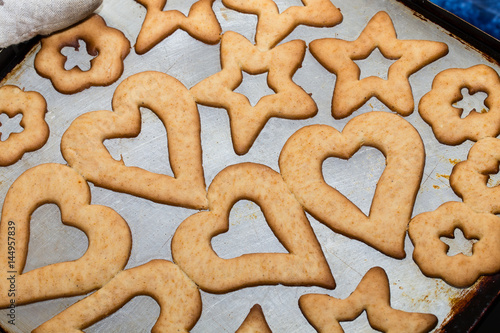 Raw cookies on black baking pan.