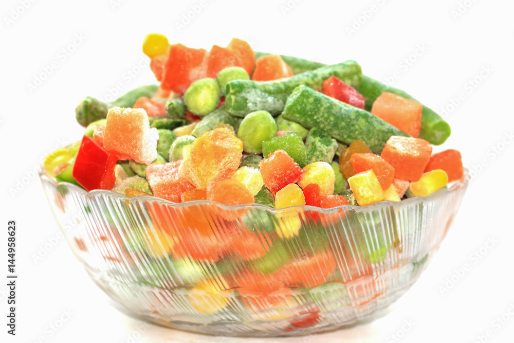 Frozen mixed vegetables in bowl on white background