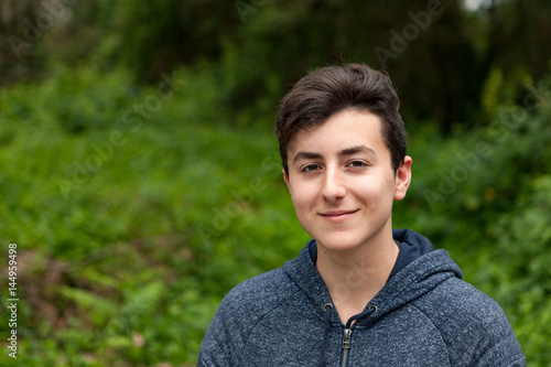 Attractive teenager guy in a park
