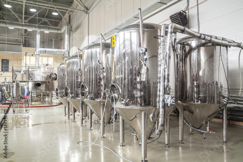 Brewery. Modern beer plant with brewering kettles, tubes and tanks made of stainless steel