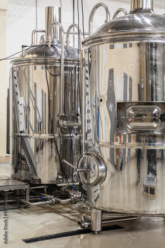 Brewery. Modern beer plant with brewering kettles, tubes and tanks made of stainless steel
