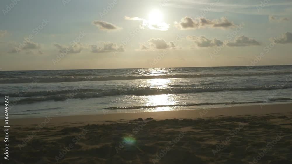 Sunset on the beach - Tranquil idyllic scene of a golden sundown over the sea, waves slowly splashing on the sand. Sunrise over ocean. Slow motion Sunset on the beach - Tranquil idyllic scene of a golden sundown over the sea, waves slowly splashing on the sand. Sunrise over ocean. Slow motion