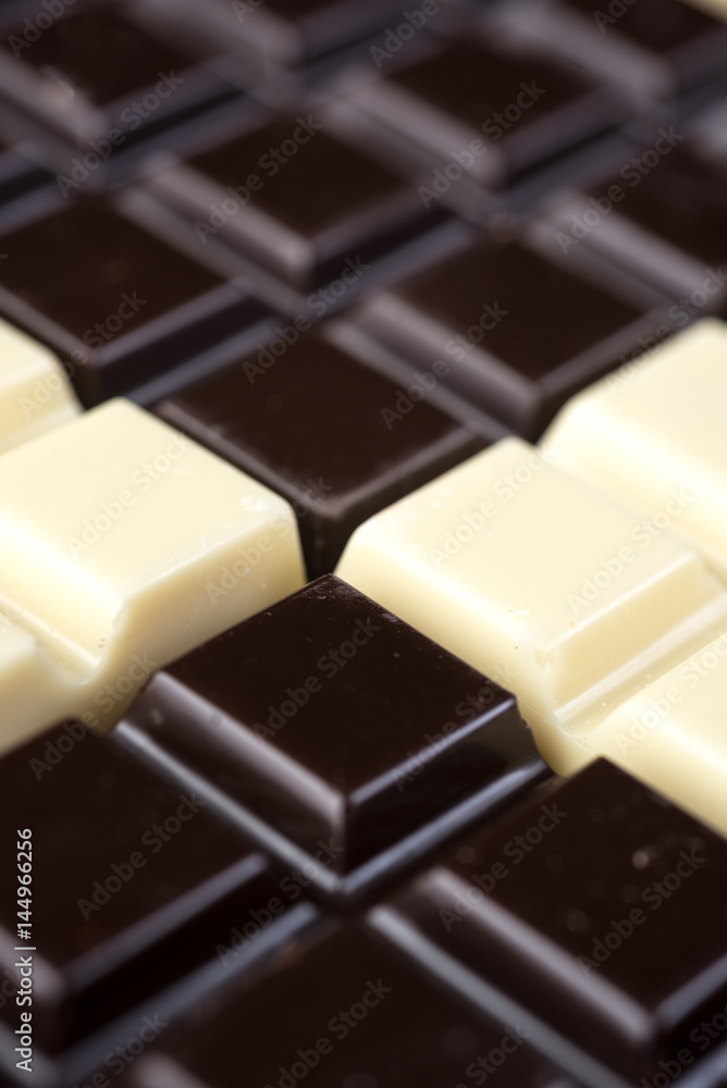 Fototapeta premium Dark and white chocolate bars combined in a pattern