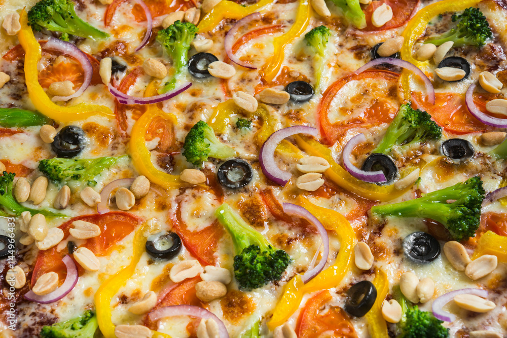 Vegetarian pizza with rosemary and spices on a light wooden background. Italian pizza on a background of green basil and fresh vegetables Vegetarian pizza with rosemary and spices on a light wooden background. Italian pizza on a background of green basil and fresh vegetables