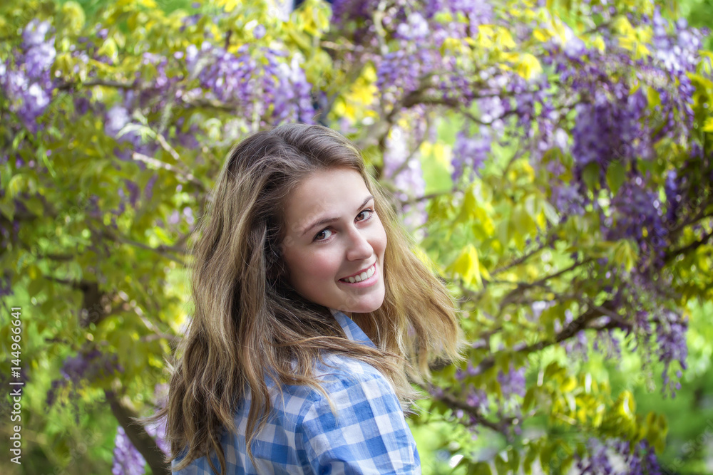 Spring beauty girl outdoors. Blooming Wisteria tree. Spring beauty girl outdoors. Blooming Wisteria tree.
