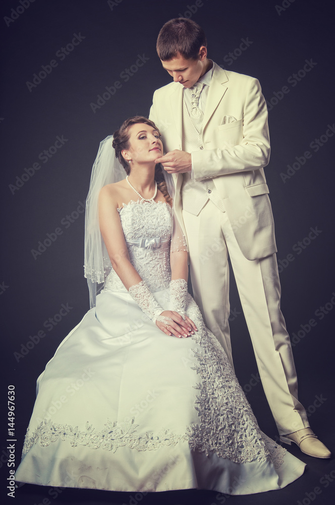 Groom and bride on a black background