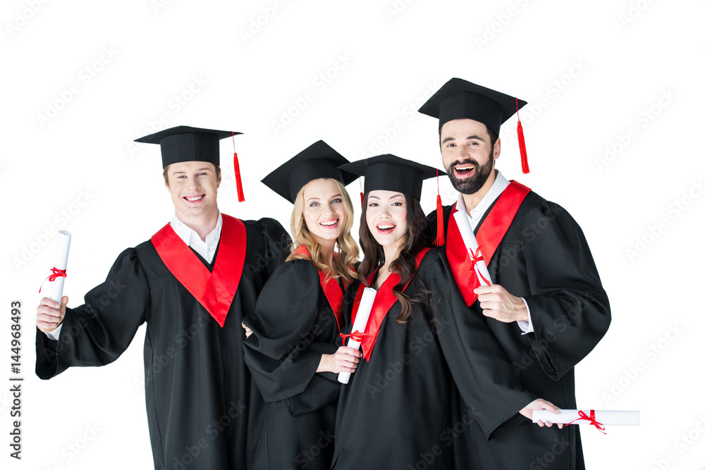 Happy young men and women in academic caps holding certificates and smiling Happy young men and women in academic caps holding certificates and smiling