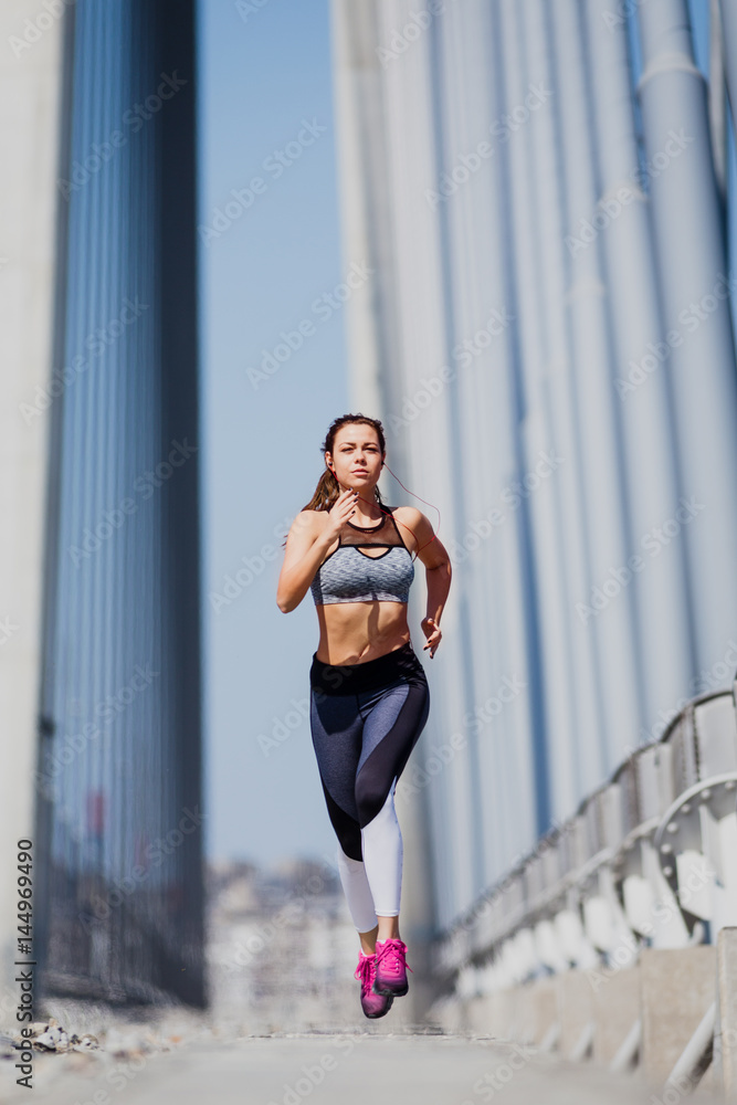 Woman running in urban environment 